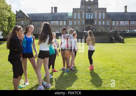 Group of students taking break in field Stock Photo