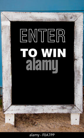 Enter To Win message written on vintage chalkboard, conceptual image Stock Photo
