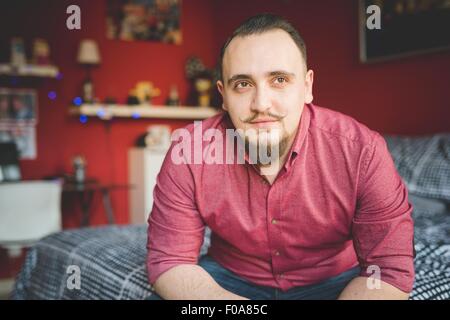 Portrait of young man in bedroom Stock Photo