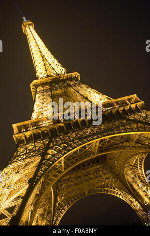 The lights of the Eiffel tower in the night in Paris in France Stock Photo