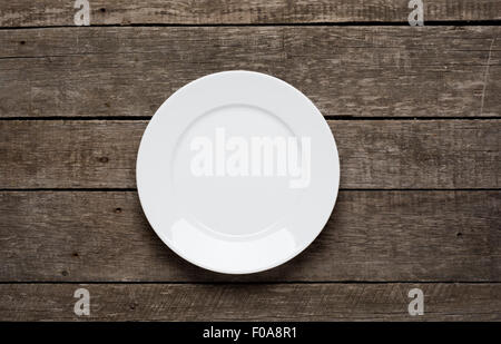 Empty plate on old wooden background. Top view Stock Photo