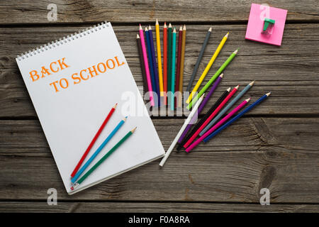 Back to School pupils art pencils and pad on wooden desk from above Stock Photo