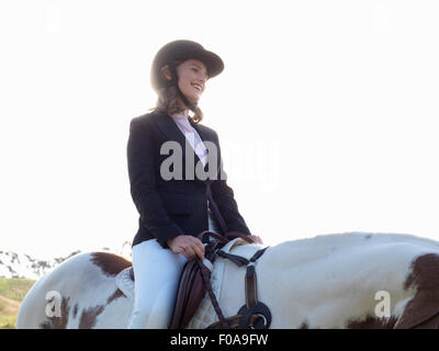 Teenage girl riding horse Stock Photo