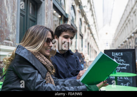 Couple reading lunch menu in Galeries Royales Saint-Hubert, Brussels, Flanders, Belgium Stock Photo