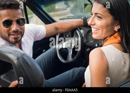 Mid adult couple in convertible car, rear view Stock Photo