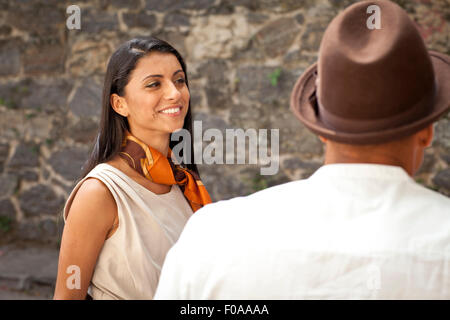 Mid adult woman standing with man, smiling Stock Photo