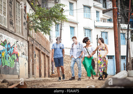 Group of friends, walking along street together