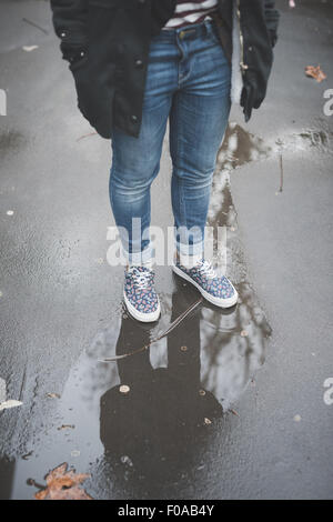 Woman on wet street Stock Photo