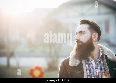 Young bearded man, building in background Stock Photo