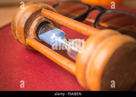 Hourglass placed on the desk Stock Photo
