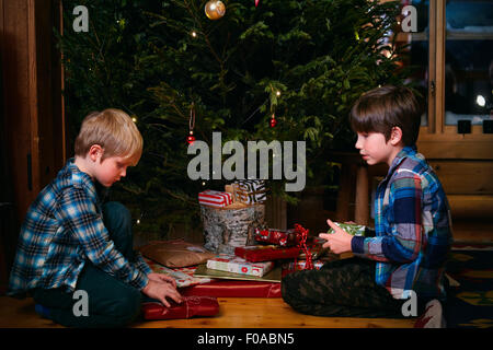 Two brothers opening Christmas presents Stock Photo