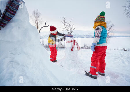 Two boys making snowmen , Hemavan,Sweden Stock Photo