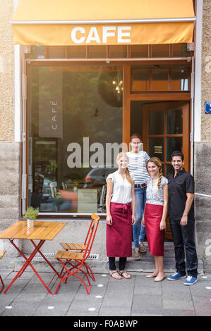 Waiter and waitresses outside cafe, portrait Stock Photo