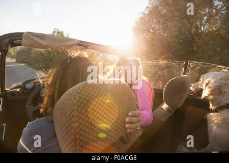 Two mature women in convertible car, rear view Stock Photo