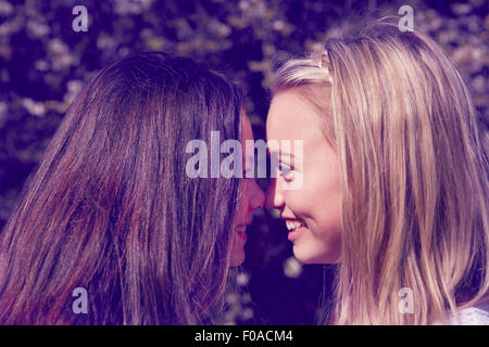 Close up portrait of two girls face to face Stock Photo