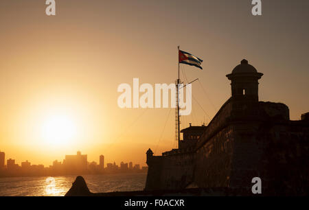 Cuban flag over El Morro Fortress at sunset, Havana, Cuba Stock Photo