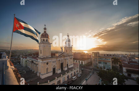 Cuban flag over Plaza de la catedral at sunset, Santiago de Cuba, Cuba Stock Photo