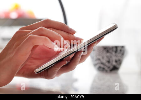 Female hands using smartphone
