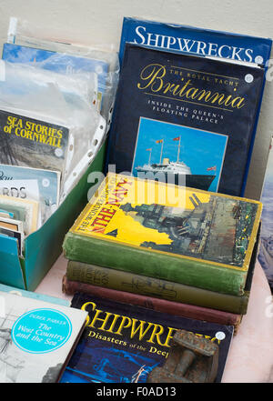 Old naval books on display in a shop window at Fowey, Cornwall, England, UK. Stock Photo
