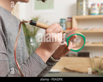 Close up of artist working on jewellery piece Stock Photo