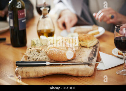 Freshly baked bread on breadboard, close up Stock Photo