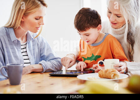 Three generation family using digital tablet Stock Photo