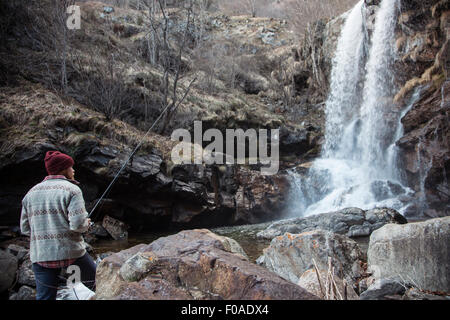 Man fishing by waterfall, River Toce, Premosello, Verbania, Piedmonte, Italy Stock Photo