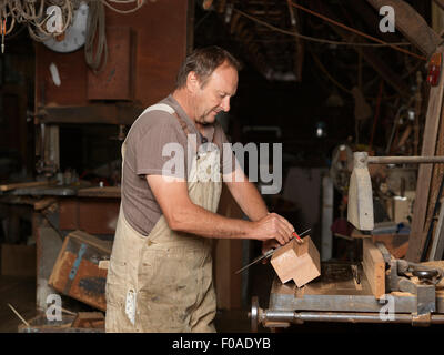 Boat builder in workshop Stock Photo