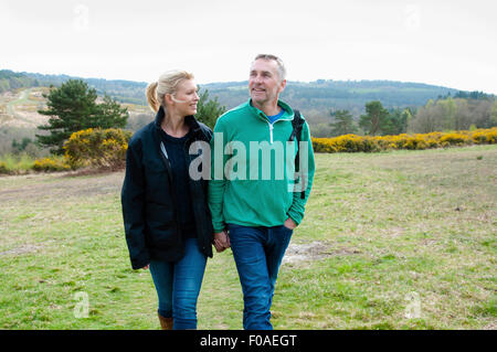 Hiking couple walking in rural landscape Stock Photo