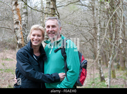 Portrait of hiking couple walking in woods Stock Photo