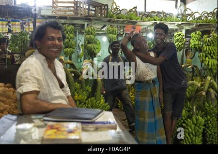 Two banana vendors standing in shop at Colombo, Sri Lanka Stock Photo