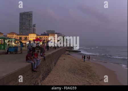 People at promenade in front of Galle Face Hotel at dusk, Colombo, Sri Lanka Stock Photo