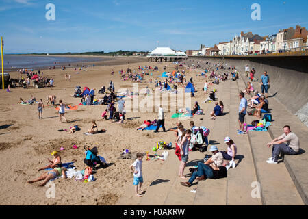 holiday makers enjoying the sunshine on the beach in Burnham on sea Somerset uk Stock Photo