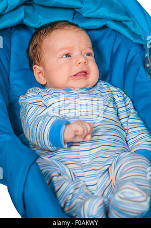 Portrait of a 2 months old baby boy sitting in a safety seat. Stock Photo