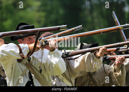 Continental Army soldiers firing muskets during Revolutionary War reenactment at Jockey Hollow in Morristown National Historical Park,New Jersey, USA Stock Photo