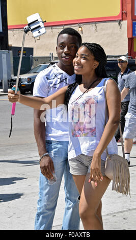 Two nice looking teenagers taking a selfie across the street from Nathan's in Coney Island, Brooklyn, New York Stock Photo