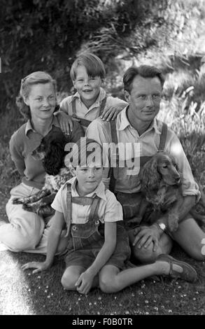 Portrait of a family sitting in a garden Stock Photo