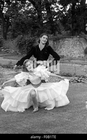 Two young women dancing in a garden Stock Photo