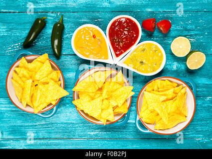 Plate of nachos with different dips Stock Photo