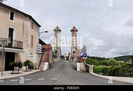 Suspension bridge at Douelle is a commune in the Lot department in south-western France Midi Pyrenees It is a port on the left bank of the Lot River. The village's history has been closely linked with the transport of local wine, as well as the manufacture of barrels. Stock Photo