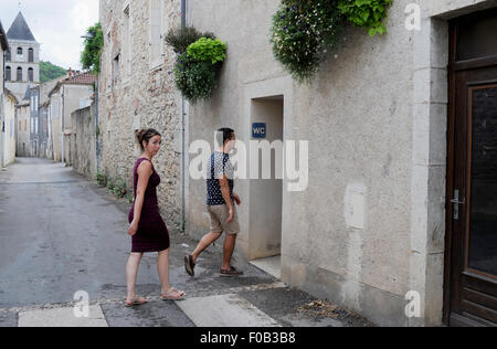 Tourists visiting public toilets at Douelle  a commune in the Lot department in south-western France Midi Pyrenees It is a port on the left bank of the Lot River. Stock Photo