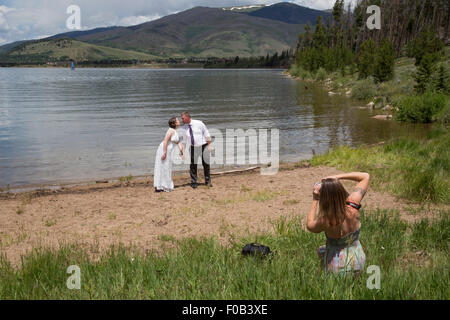 Dillon, Colorado - A photographer takes pictures during the wedding of a young couple. Stock Photo