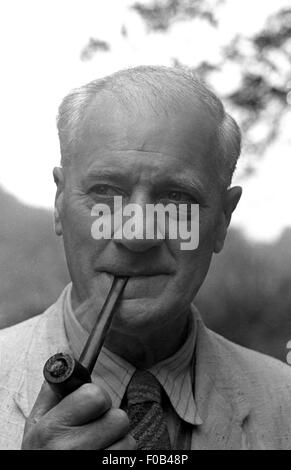 An old man smoking a pipe. Stock Photo