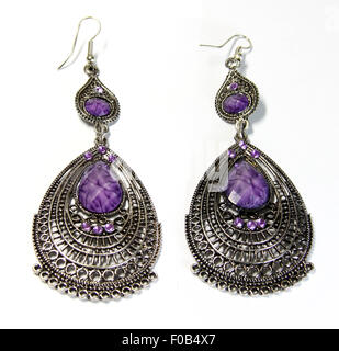 metal earing with violet stone on white background Stock Photo