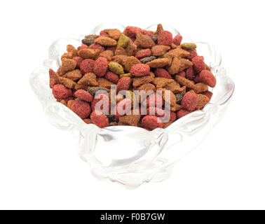 A glass bowl filled with generic dry cat food isolated on a white background. Stock Photo