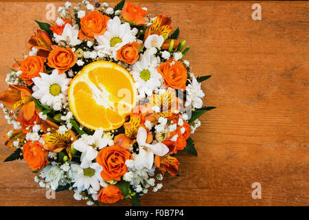 Bouquet of roses and daisies with orange in the center Stock Photo