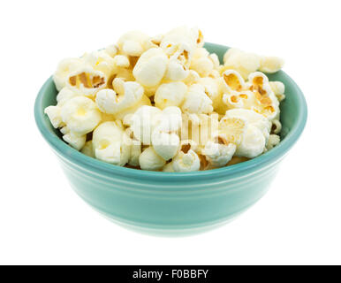 A small bowl filled with a serving of white cheddar cheese flavored popcorn isolated on a white background. Stock Photo