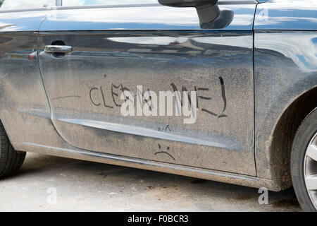 Clean Me! hand written on dirty car England UK europe Stock Photo