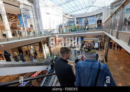 people going down on escalators in Birmingham bullring shopping centre UK Stock Photo
