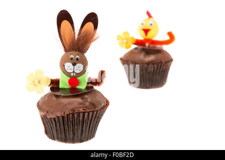 Chocolate Easter cupcakes with a bunny and chick character decoration - shallow depth of field with a white background Stock Photo